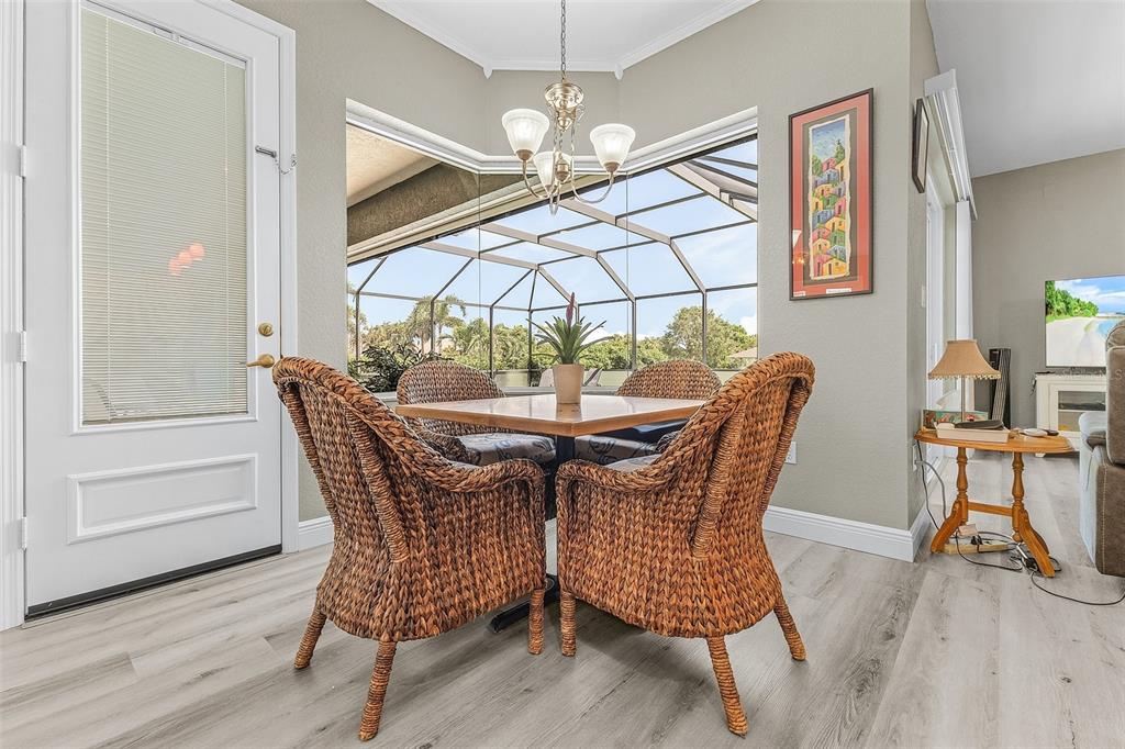 7130 Scarlet Sage Court Punta Gorda, FL 33955 - Photo 12 of 26 a view of a dining room with furniture and wooden floor