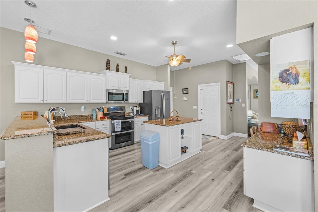 7130 Scarlet Sage Court Punta Gorda, FL 33955 - Photo 14 of 26 a kitchen with granite countertop a sink cabinets and counter space