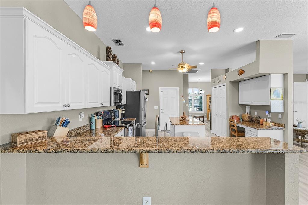7130 Scarlet Sage Court Punta Gorda, FL 33955 - Photo 15 of 26 a kitchen with stainless steel appliances granite countertop a sink stove and refrigerator
