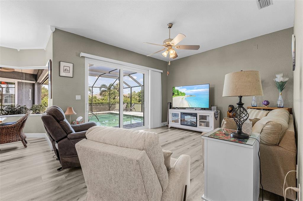 7130 Scarlet Sage Court Punta Gorda, FL 33955 - Photo 16 of 26 a living room with furniture a window and a chandelier
