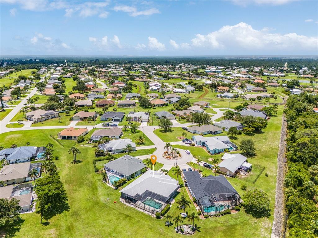 7130 Scarlet Sage Court Punta Gorda, FL 33955 - Photo 25 of 26 an aerial view of residential houses with outdoor space and trees