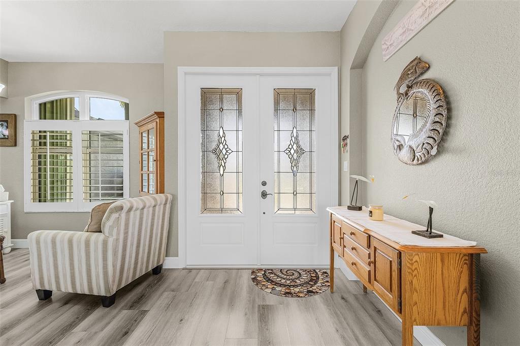 7130 Scarlet Sage Court Punta Gorda, FL 33955 - Photo 5 of 26 a spacious bedroom with windows and wooden floor