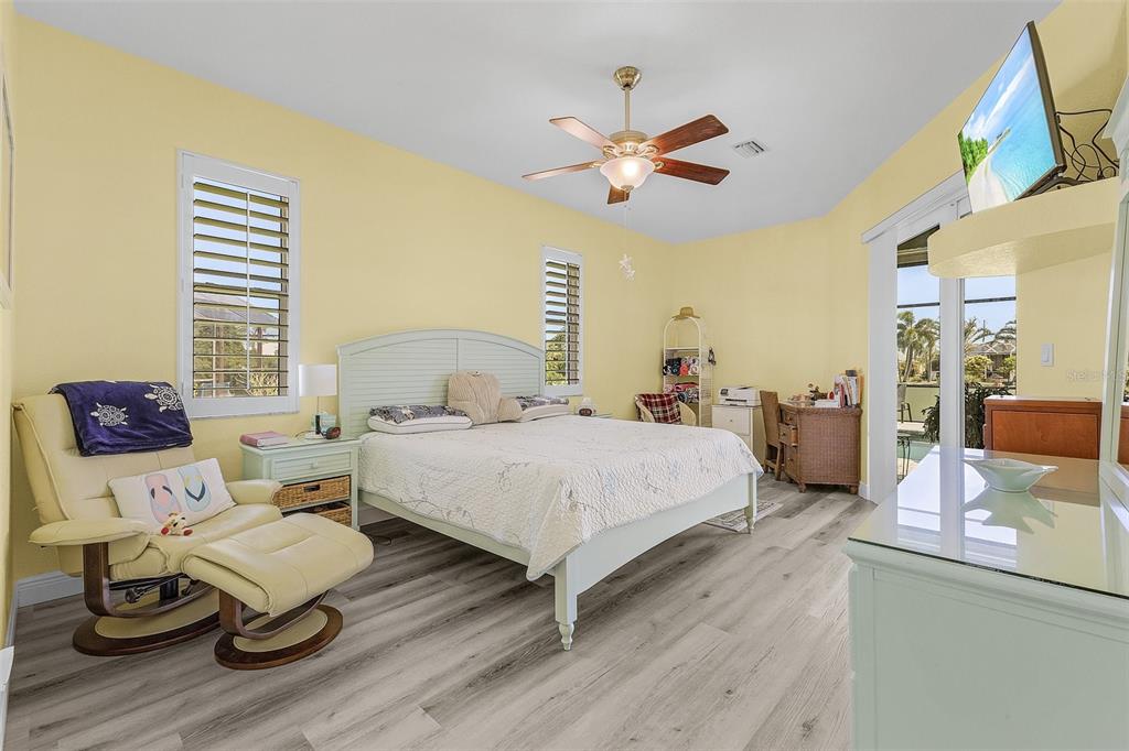 7130 Scarlet Sage Court Punta Gorda, FL 33955 - Photo 7 of 26 a bedroom with a bed and wooden floor