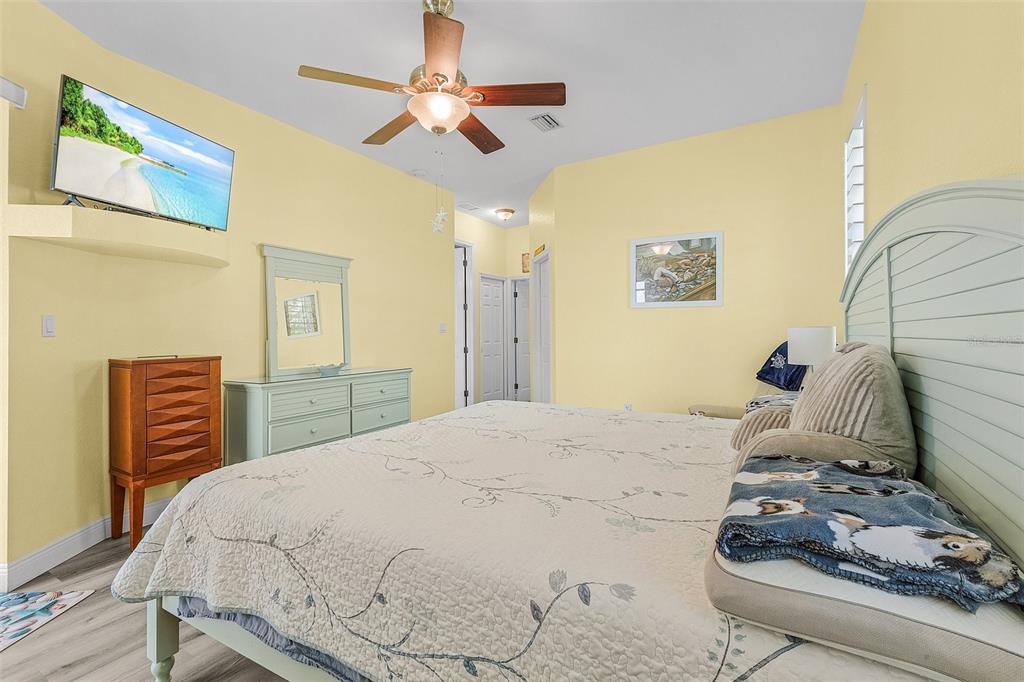 7130 Scarlet Sage Court Punta Gorda, FL 33955 - Photo 8 of 26 a bedroom with a bed and a chandelier