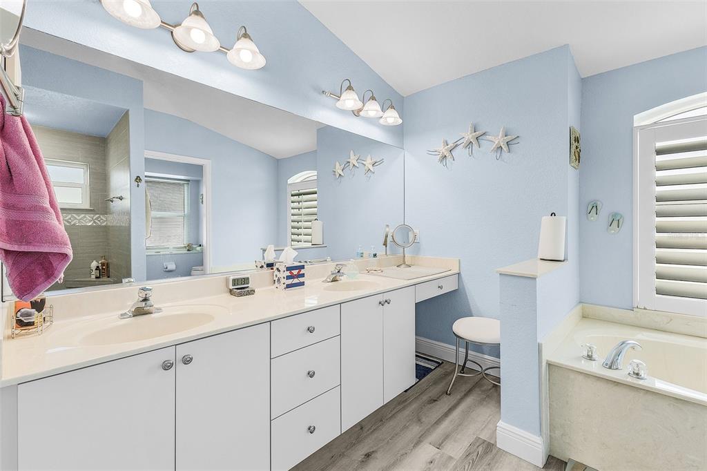 7130 Scarlet Sage Court Punta Gorda, FL 33955 - Photo 10 of 26 a bathroom with a double vanity sink mirror bathtub and toilet