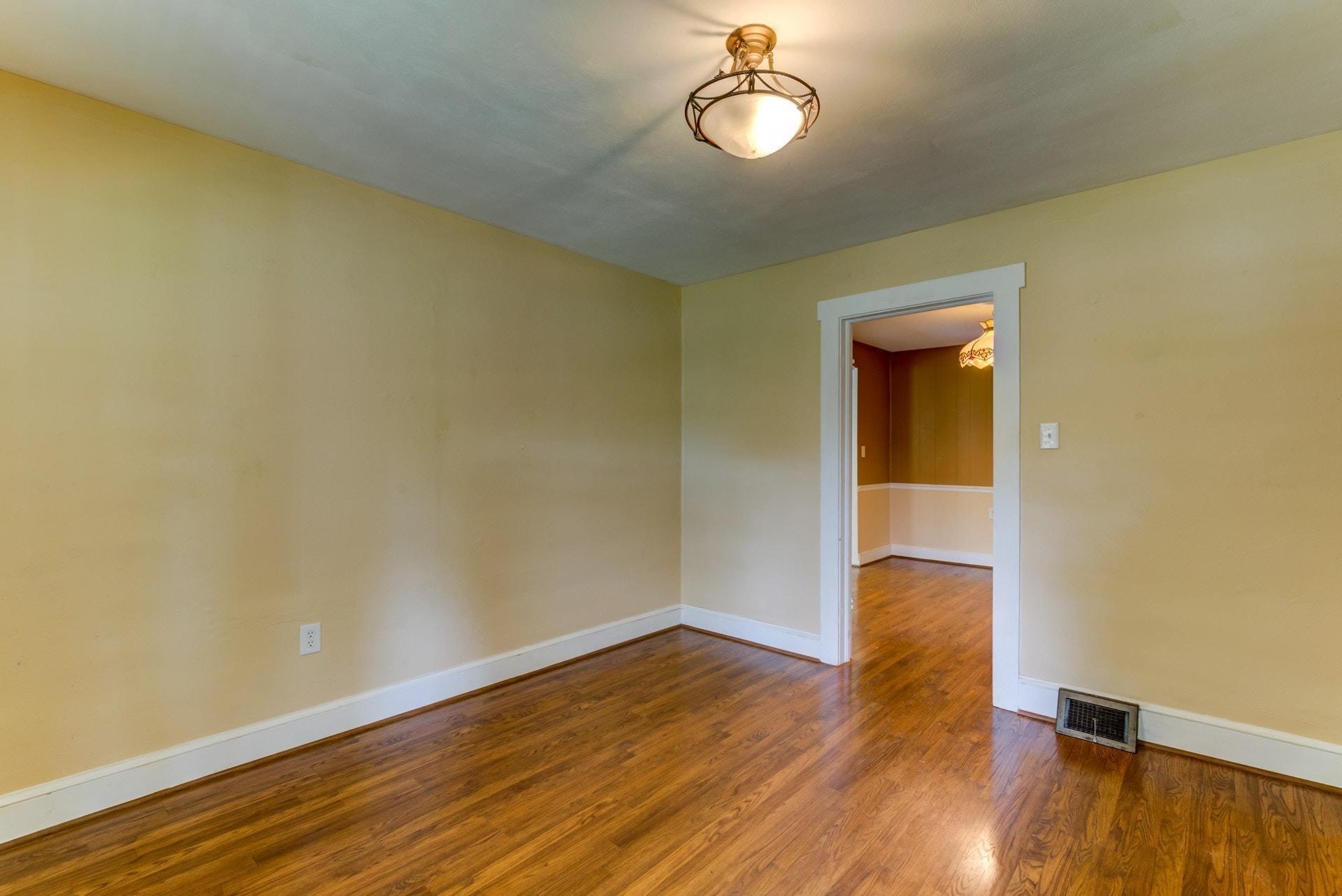 4541 Cowman Road Roanoke, VA 24014 - Photo 3 of 23 an empty room with wooden floor and windows