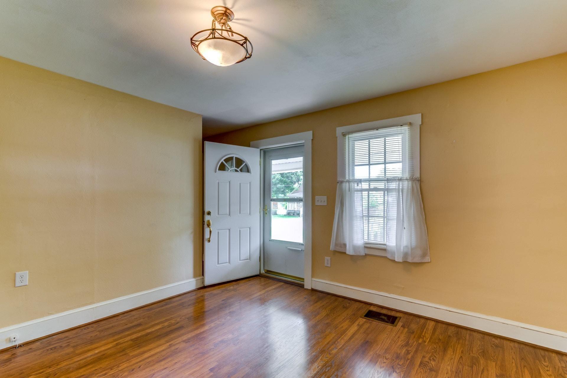 4541 Cowman Road Roanoke, VA 24014 - Photo 4 of 23 an empty room with wooden floor and windows