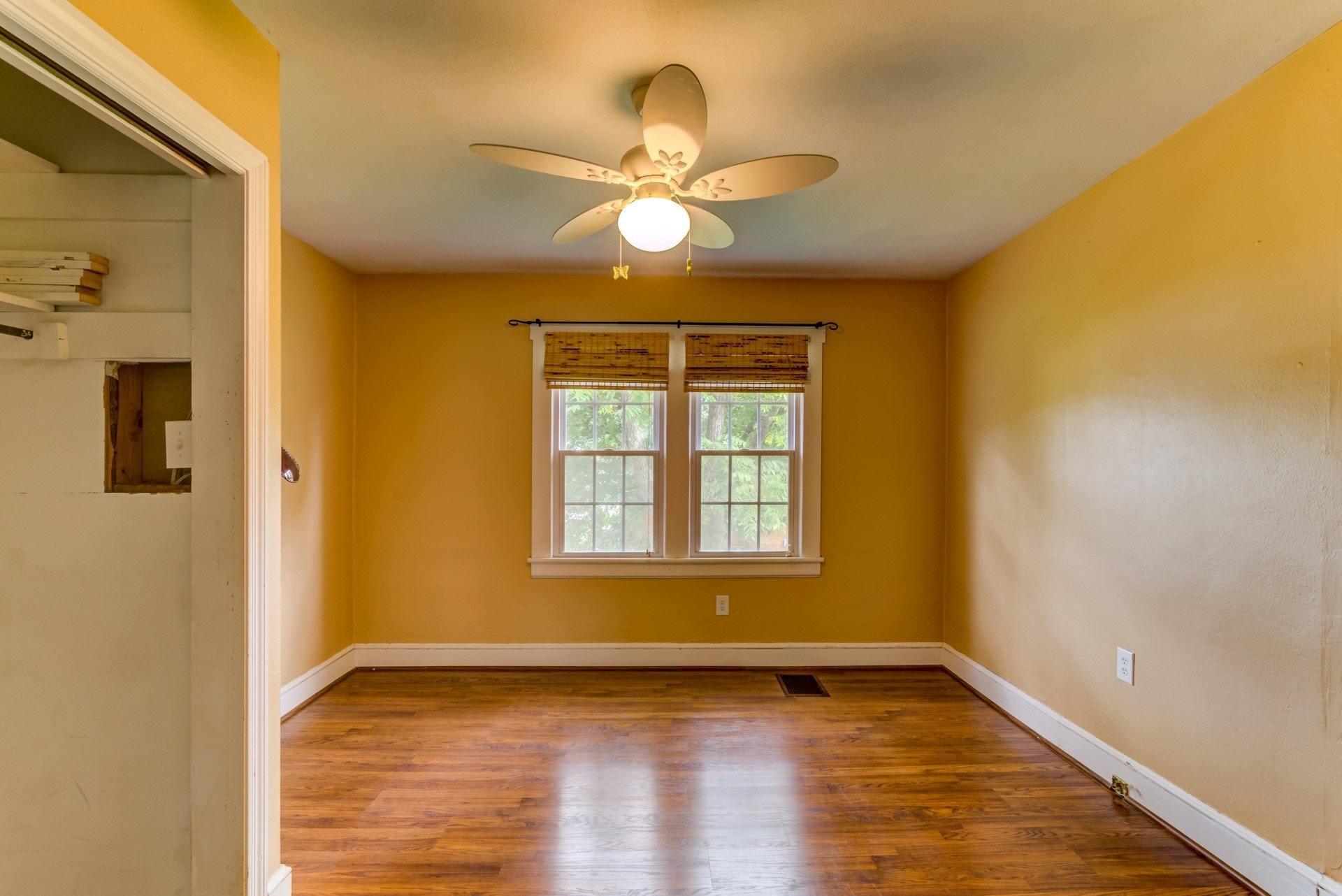 4541 Cowman Road Roanoke, VA 24014 - Photo 6 of 23 a view of an empty room with wooden floor and a window