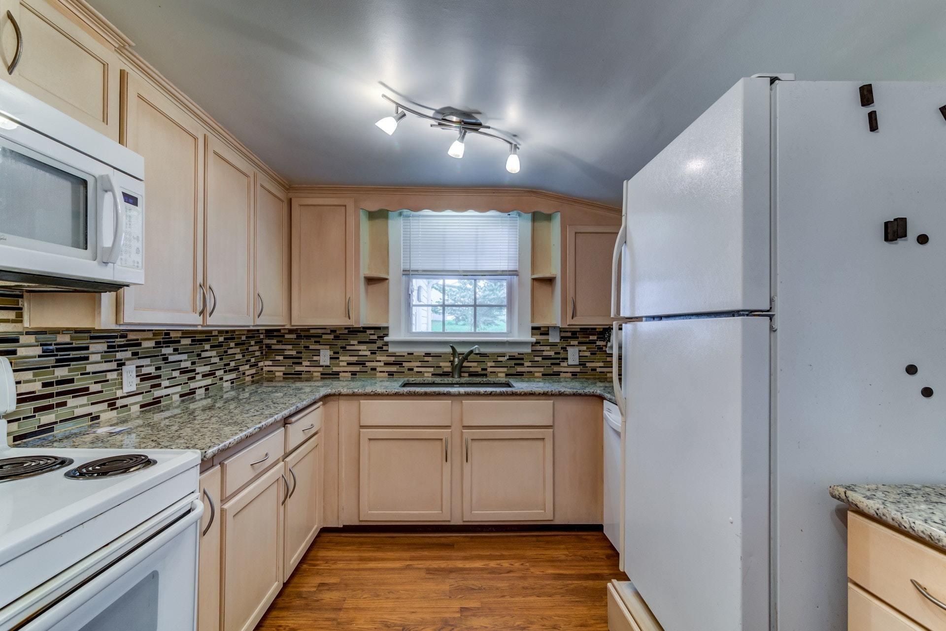 4541 Cowman Road Roanoke, VA 24014 - Photo 8 of 23 a kitchen with stainless steel appliances granite countertop a sink stove and refrigerator
