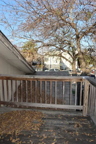 a front view of a house with a large tree