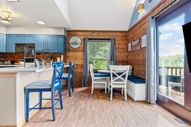 a kitchen with stainless steel appliances granite countertop a refrigerator a stove and a sink