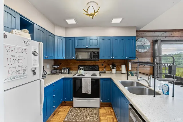a kitchen with stainless steel appliances granite countertop a refrigerator and a stove