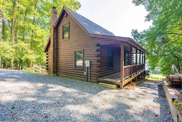 a view of a yard with a house and a tree