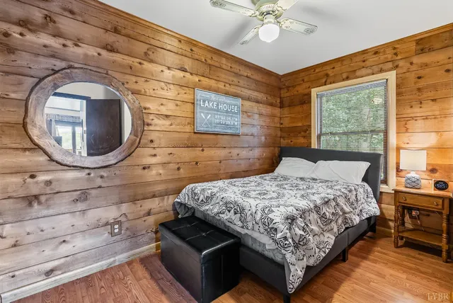 a bedroom with a bed and a tv on the dresser
