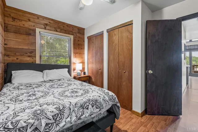a bedroom with a bed and a flat tv screen on dresser