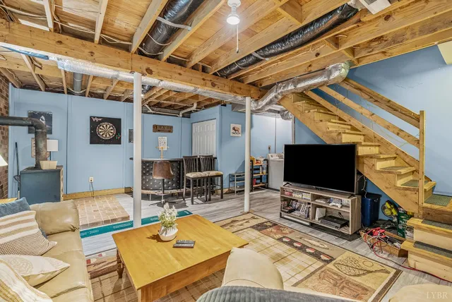 a view of storage and utility room with refrigerator and wooden floor