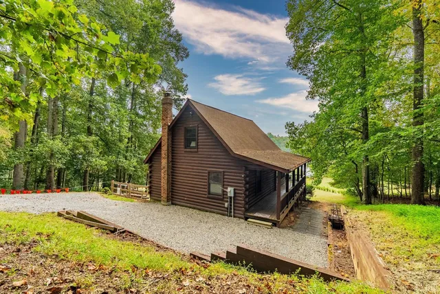 a view of a swimming pool with an outdoor seating and a yard