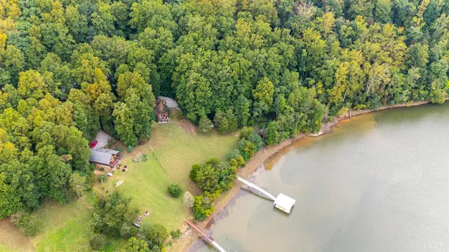 a living room with furniture a fireplace and a ceiling fan