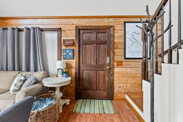 a living room with furniture a flat screen tv and a floor to ceiling window
