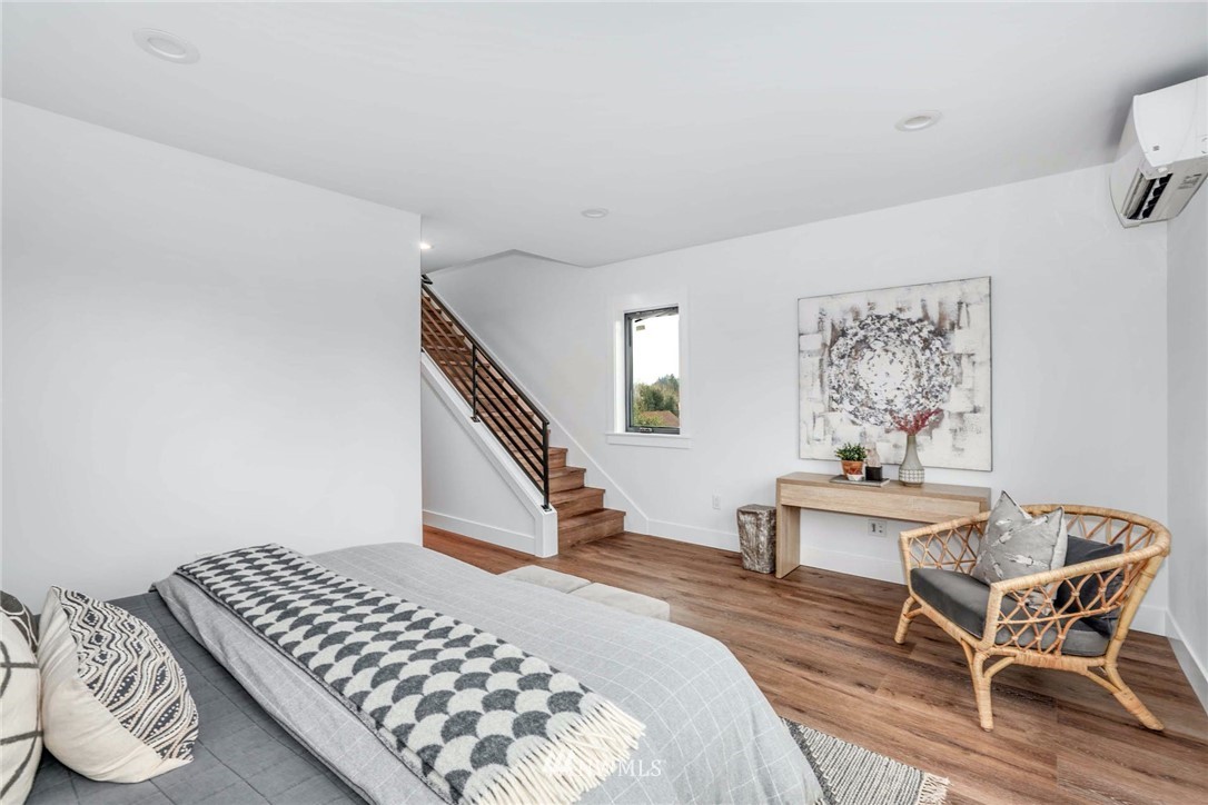 1619 North 50th Street Seattle, WA 98103 - Photo 14 of 37 a bedroom with a bed and a table in it