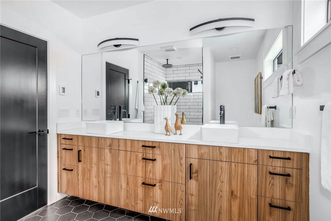 1619 North 50th Street Seattle, WA 98103 - Photo 16 of 37 a spacious bathroom with a double vanity sink and a mirror