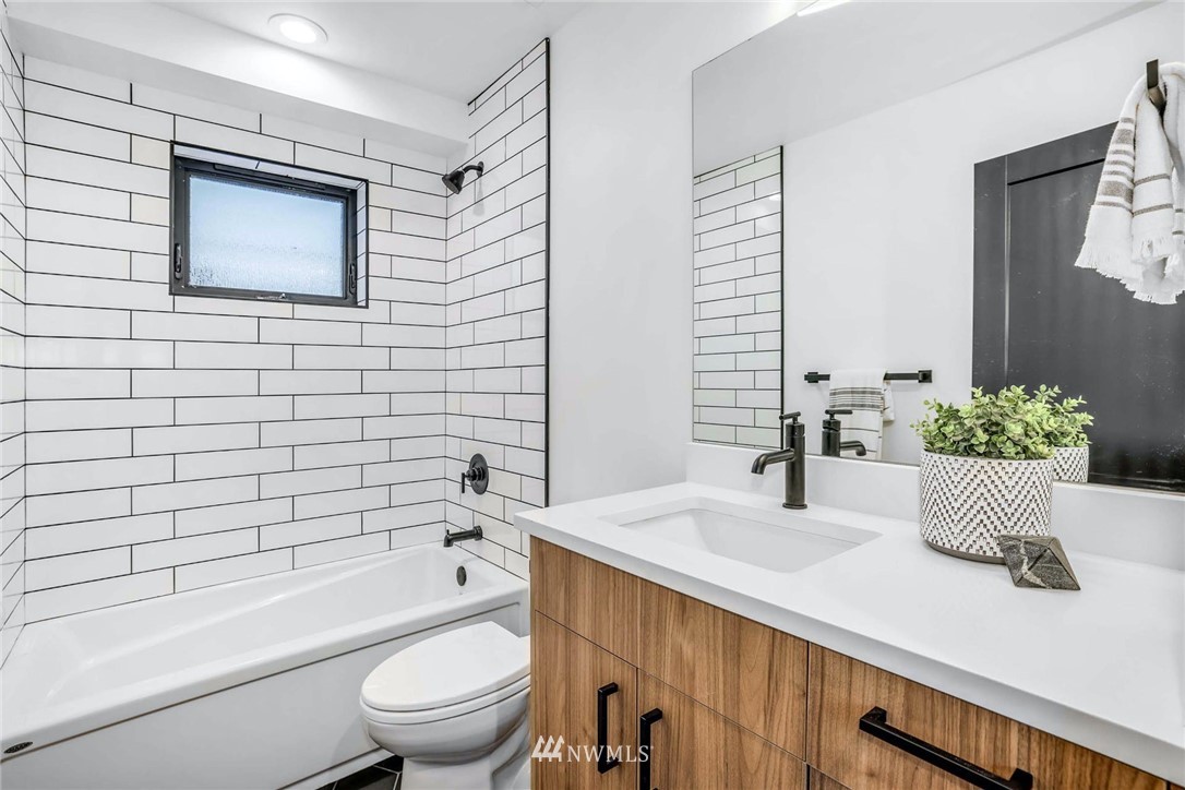 1619 North 50th Street Seattle, WA 98103 - Photo 18 of 37 a bathroom with a sink a toilet and bathtub