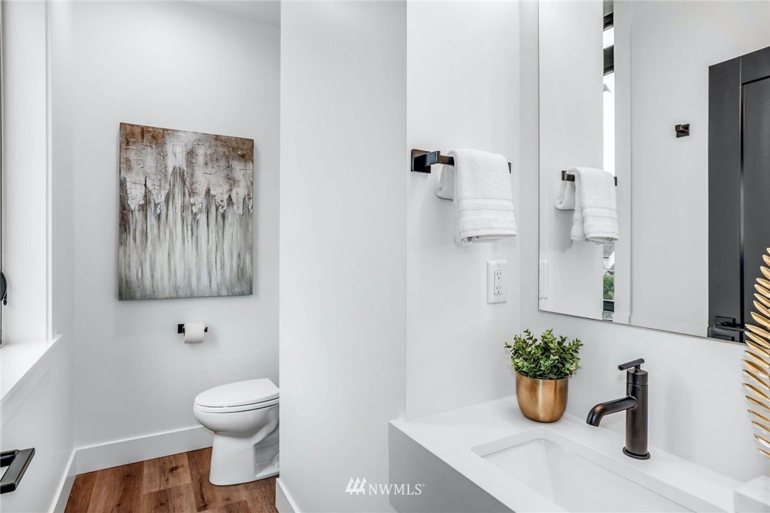 1619 North 50th Street Seattle, WA 98103 - Photo 21 of 37 a bathroom with a potted plant and a toilet