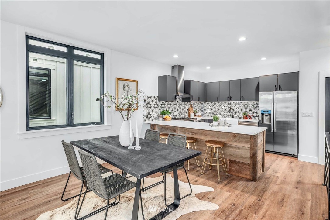 1619 North 50th Street Seattle, WA 98103 - Photo 7 of 37 a kitchen with a table and chairs in it