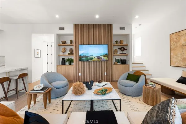 a living room with furniture and a painting on the wall