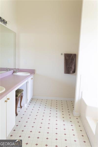 6232 Springwater Lane Lithonia, GA 30058 - Photo 14 of 32 a bathroom with a sink a vanity and a mirror