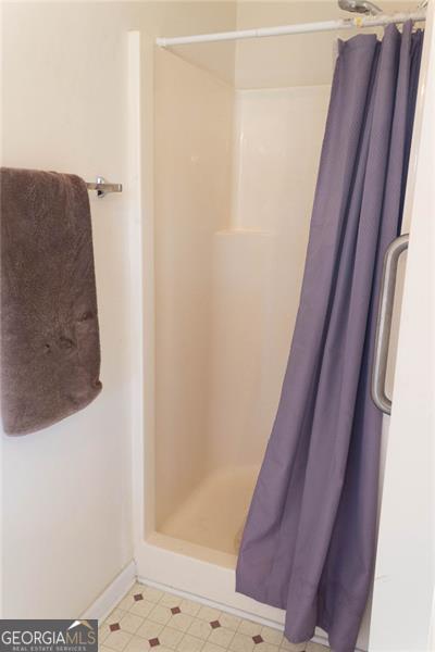 6232 Springwater Lane Lithonia, GA 30058 - Photo 16 of 32 a bathroom with a shower and a sink