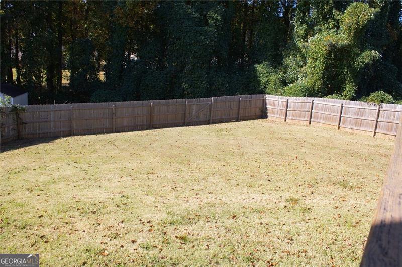 6232 Springwater Lane Lithonia, GA 30058 - Photo 19 of 32 a white house covered with snow in the background