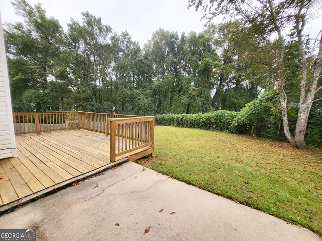 a view of a balcony with yard