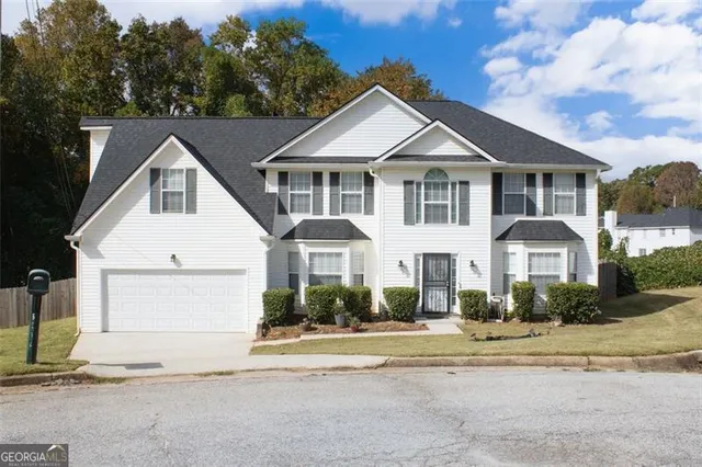 a front view of a house with a yard