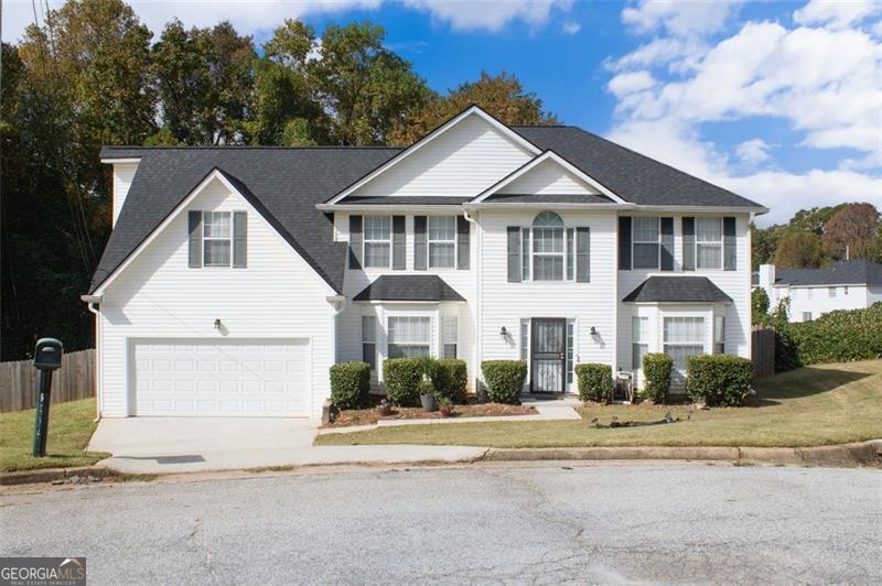 6232 Springwater Lane Lithonia, GA 30058 - Photo 30 of 32 a front view of a house with a yard