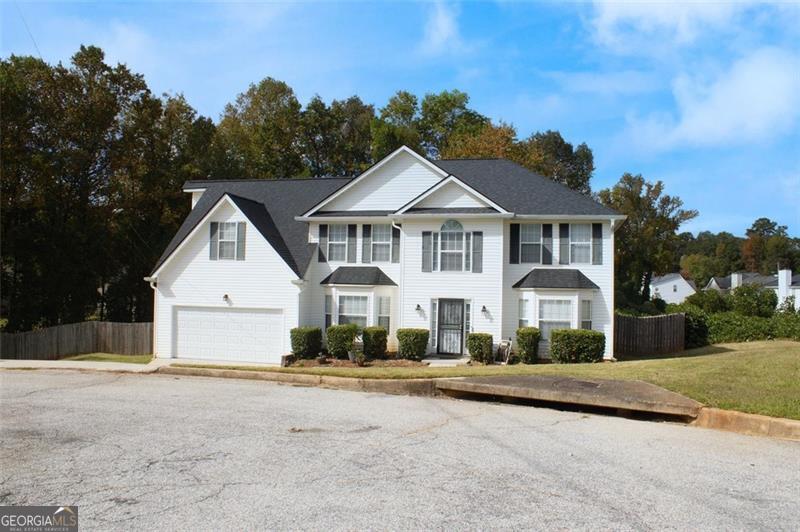 6232 Springwater Lane Lithonia, GA 30058 - Photo 31 of 32 a front view of a house with a yard and trees