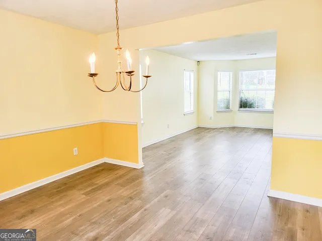 a view of a room with wooden floor and window
