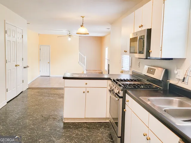 a kitchen with a sink stove and refrigerator