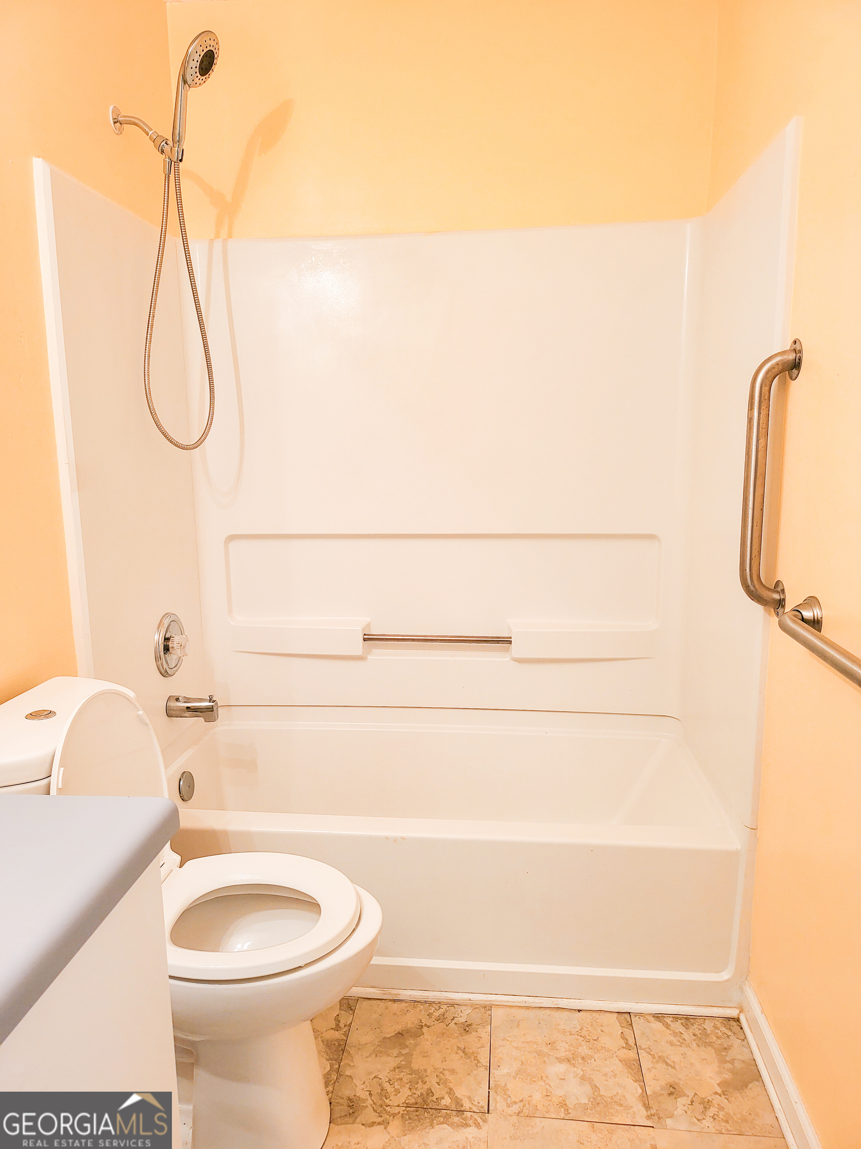 6232 Springwater Lane Lithonia, GA 30058 - Photo 9 of 32 a bathroom with a sink a toilet and a shower
