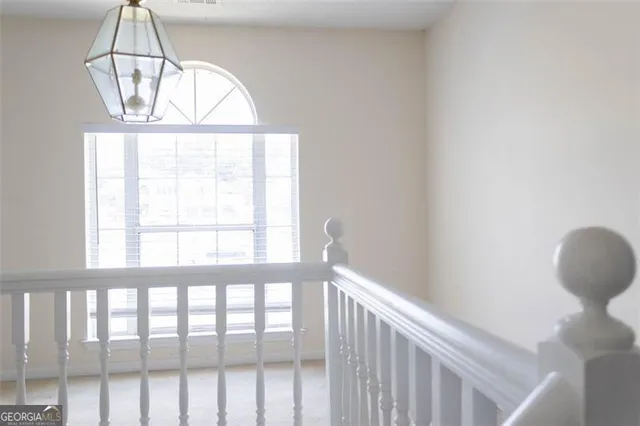 a view of a room that has a window and wooden floor