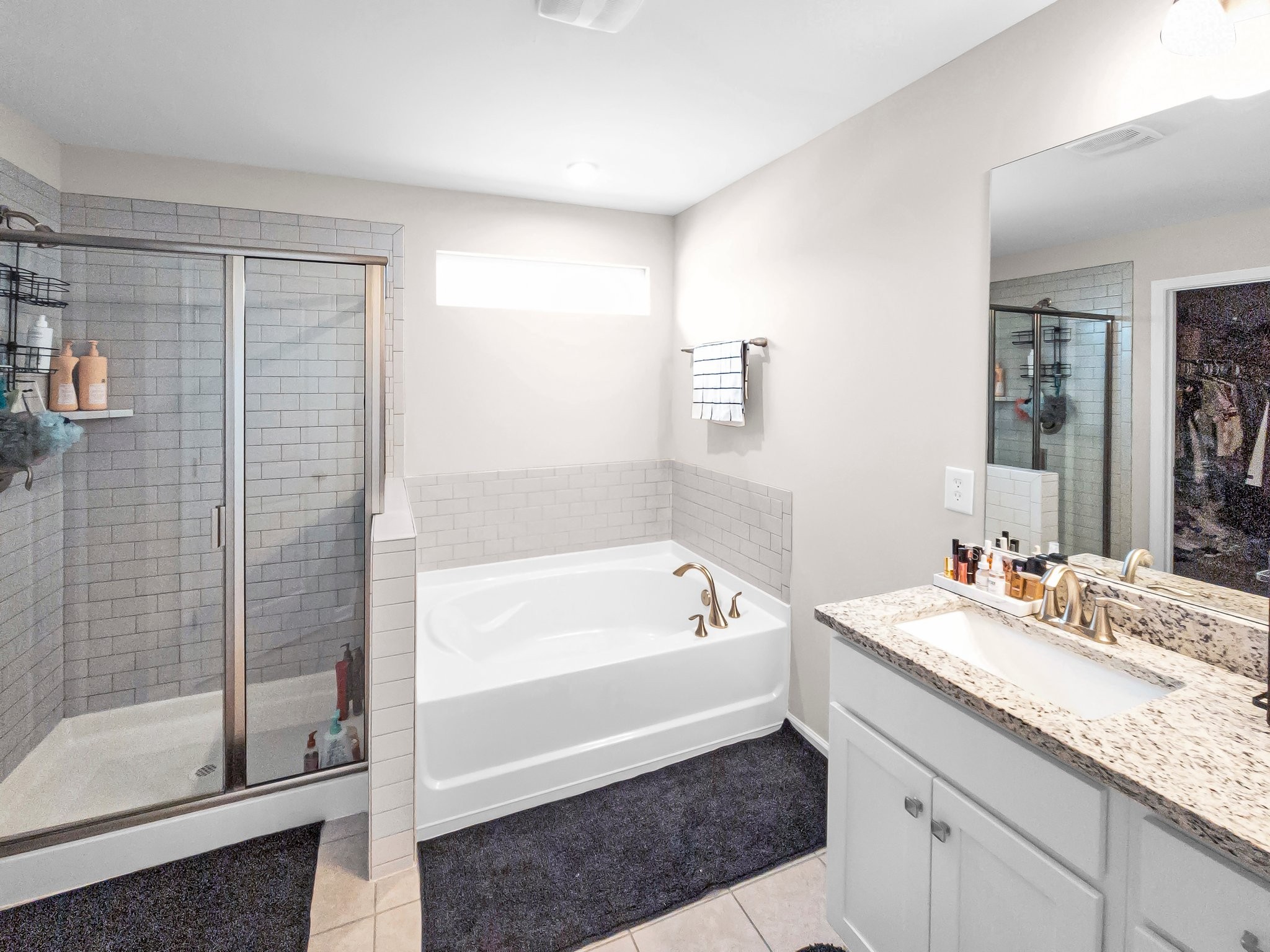 314 Disley Way Murfreesboro, TN 37128 - Photo 20 of 25 a bathroom with a tub a sink and mirrors