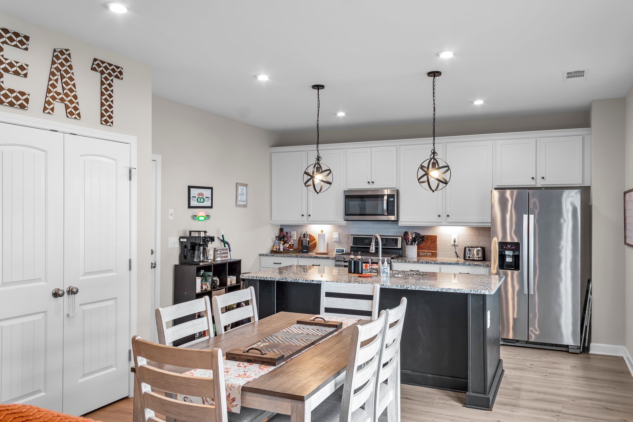 314 Disley Way Murfreesboro, TN 37128 - Photo 6 of 25 a kitchen with stainless steel appliances kitchen island granite countertop a refrigerator a stove a sink dishwasher and a wooden cabinets with wooden floor