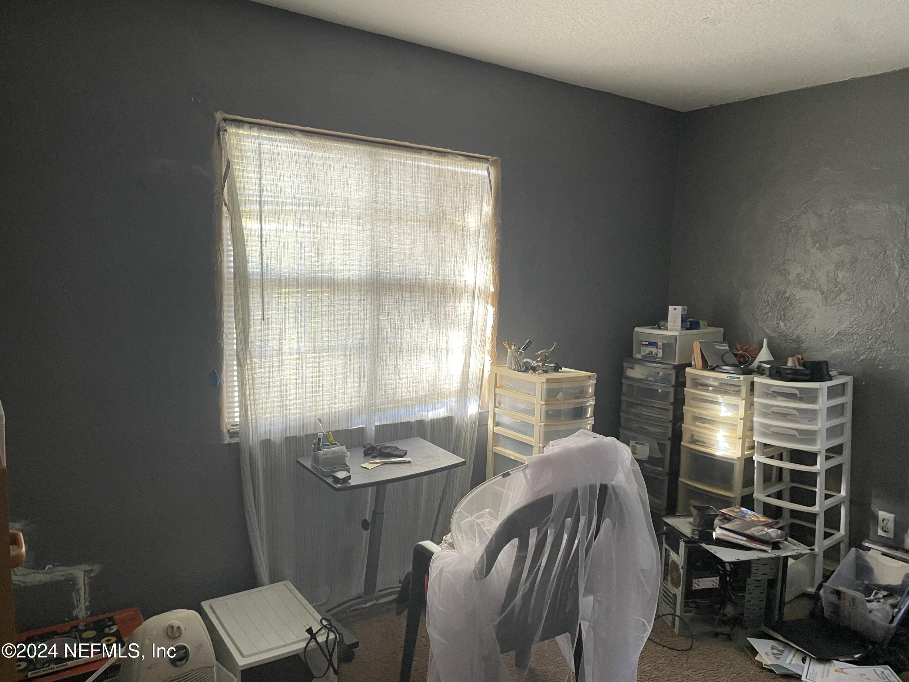 6713 Ector Road Jacksonville, FL 32211 - Photo 8 of 12 a view of a workspace with furniture and a window