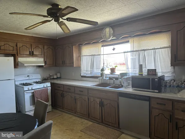 a kitchen with sink window and cabinets