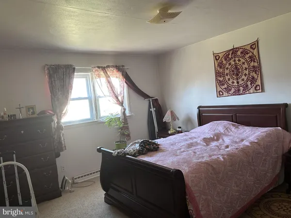 a bed sitting in a bedroom next to a window