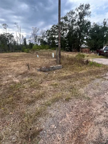a view of a yard with wooden fence