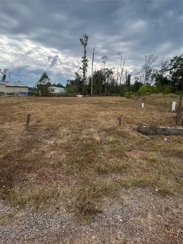 a view of a yard with wooden fence