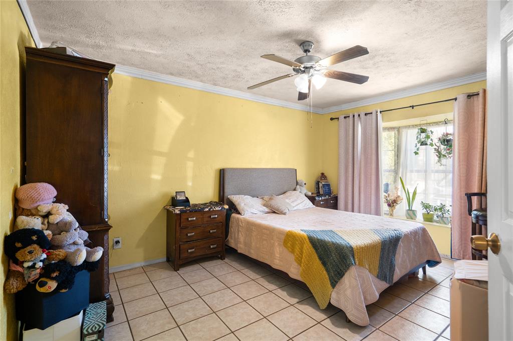 1255 Olden Street Dallas, TX 75211 - Photo 12 of 14 a bedroom with a bed and a chandelier