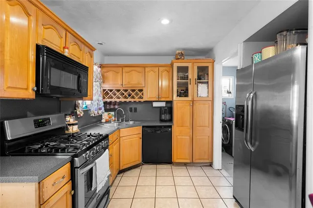 a kitchen with stainless steel appliances granite countertop a refrigerator a stove a sink and dishwasher