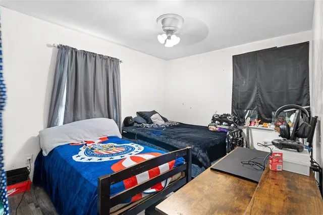 a bedroom with a bed and a chandelier